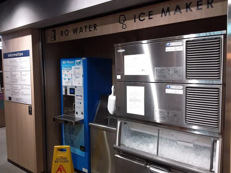 Ice maker repair technician replacing water inlet valve, auger motor, and evaporator mold assembly