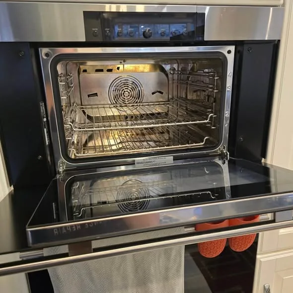 Stainless steel convection wall oven cavity and racks during element calibration in Cambridge MA