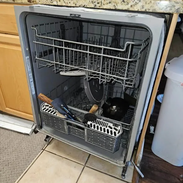 Open dishwasher stainless tub showing racks and spray arms in Beacon Hill Boston