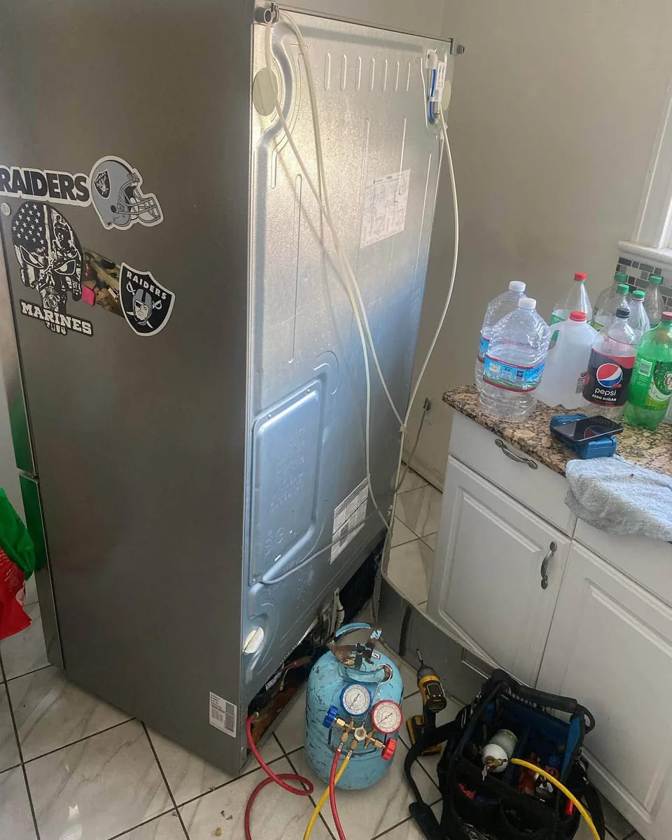 EPA 608 certified sealed system refrigerator repair with manifold gauges and recovery tank in Brookline MA
