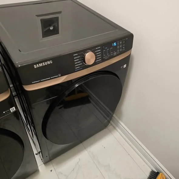 Samsung black stainless front-load clothes dryer in modern laundry room in Seaport Boston